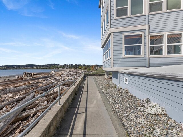 view of side of home with a water view