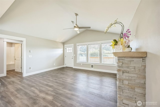 178 Pacific Blvd NW, Ocean Shores, WA 98569 - unfurnished living room with vaulted ceiling, visible vents, a ceiling fan, wood finished floors, and baseboards