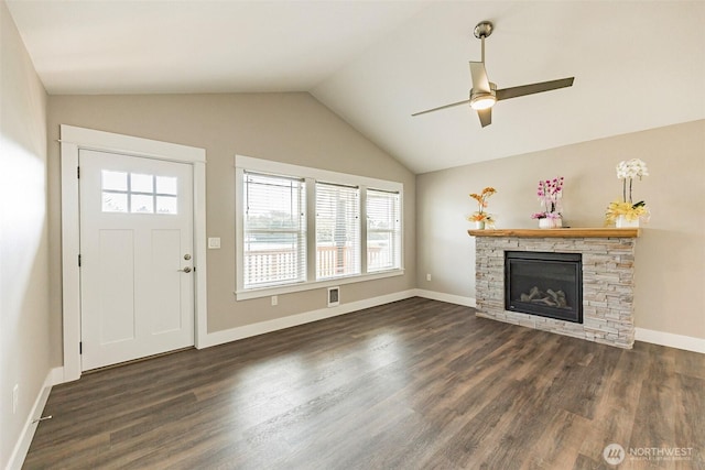 178 Pacific Blvd NW, Ocean Shores, WA 98569 - unfurnished living room with ceiling fan, a fireplace, dark wood-style floors, and plenty of natural light