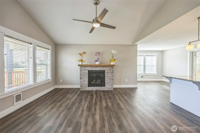 178 Pacific Blvd NW, Ocean Shores, WA 98569 - unfurnished living room with vaulted ceiling, a ceiling fan, a stone fireplace, and visible vents