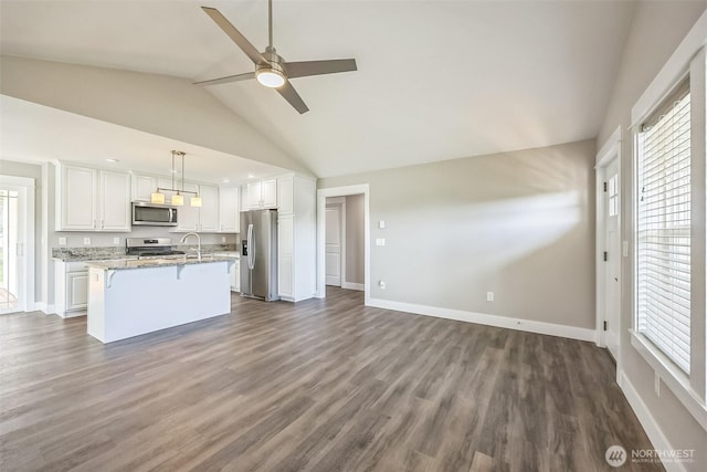 178 Pacific Blvd NW, Ocean Shores, WA 98569 - kitchen with dark wood-style floors, a ceiling fan, appliances with stainless steel finishes, a breakfast bar area, and white cabinetry