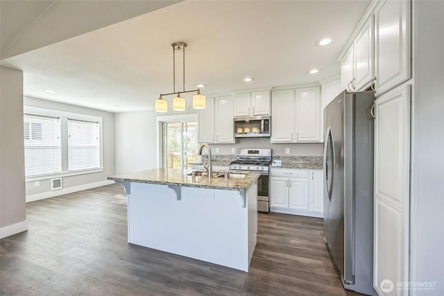 178 Pacific Blvd NW, Ocean Shores, WA 98569 - kitchen featuring white cabinetry, light stone countertops, stainless steel appliances, and dark wood-style floors