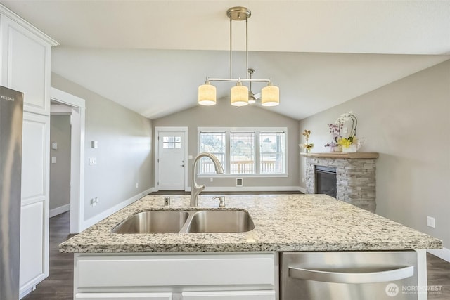 178 Pacific Blvd NW, Ocean Shores, WA 98569 - kitchen with vaulted ceiling, a sink, appliances with stainless steel finishes, white cabinets, and dark wood-style flooring