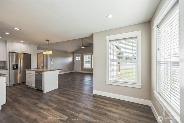 178 Pacific Blvd NW, Ocean Shores, WA 98569 - kitchen with stainless steel appliances, baseboards, hanging light fixtures, open floor plan, and ceiling fan