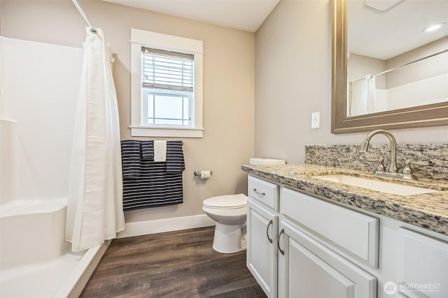 178 Pacific Blvd NW, Ocean Shores, WA 98569 - bathroom featuring toilet, wood finished floors, vanity, curtained shower, and baseboards