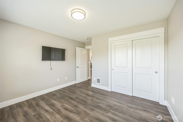 178 Pacific Blvd NW, Ocean Shores, WA 98569 - unfurnished bedroom with baseboards, visible vents, a closet, and dark wood finished floors