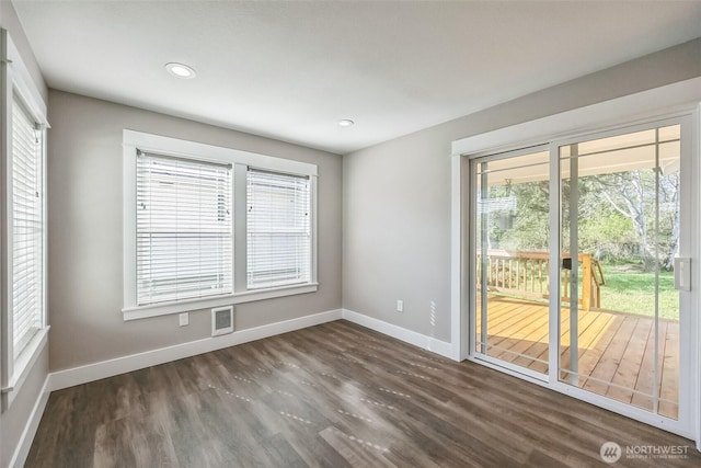178 Pacific Blvd NW, Ocean Shores, WA 98569 - unfurnished room with dark wood finished floors, a wealth of natural light, and baseboards