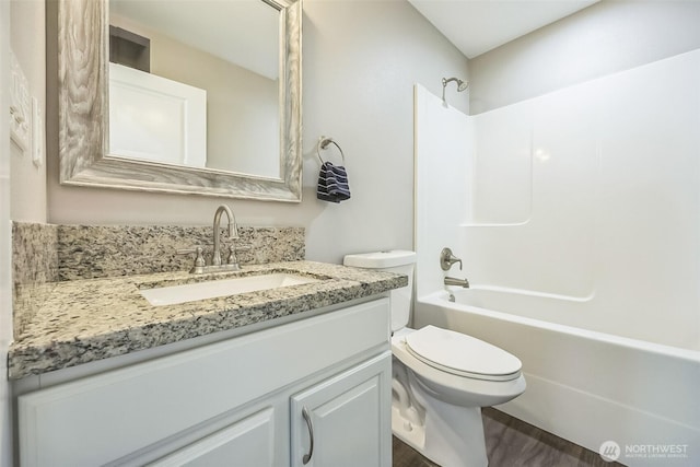 178 Pacific Blvd NW, Ocean Shores, WA 98569 - bathroom with toilet, shower / bathtub combination, vanity, and wood finished floors