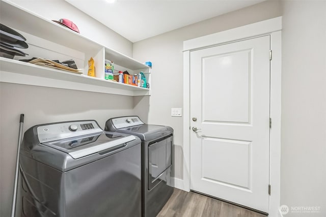 178 Pacific Blvd NW, Ocean Shores, WA 98569 - clothes washing area featuring washing machine and dryer, wood finished floors, and laundry area