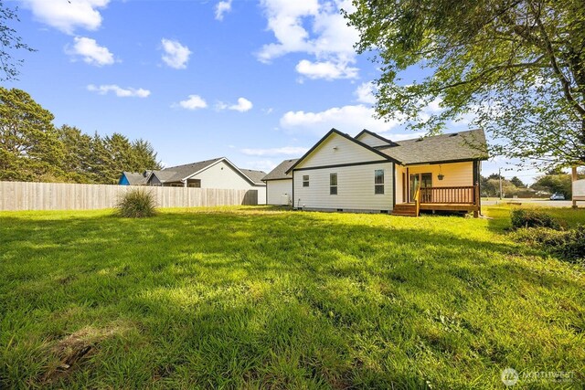 178 Pacific Blvd NW, Ocean Shores, WA 98569 - rear view of house with a lawn, crawl space, fence, and a deck