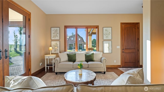 living room with baseboards and wood finished floors