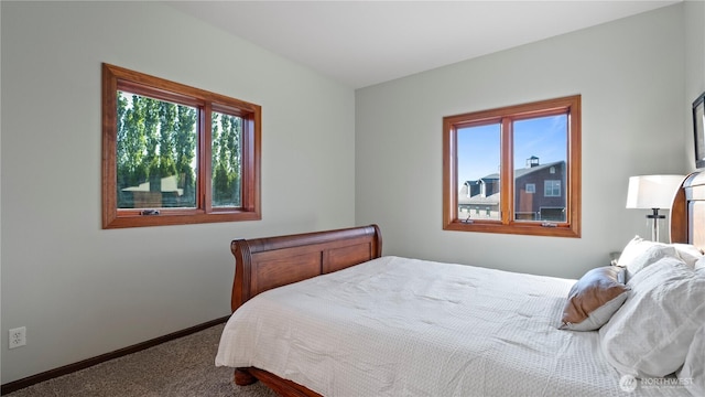 carpeted bedroom with baseboards and multiple windows