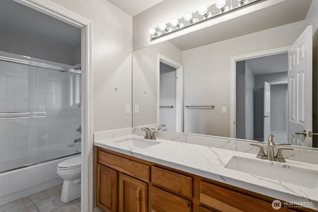 4952 160th Ct SE, Bellevue, WA 98006 - bathroom featuring double vanity, toilet, combined bath / shower with glass door, and a sink