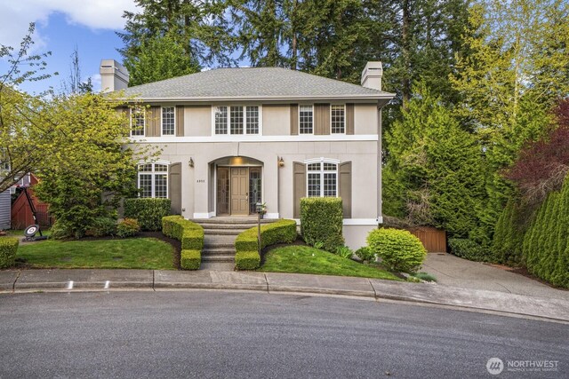 4952 160th Ct SE, Bellevue, WA 98006 - view of front facade with a chimney, stucco siding, and roof with shingles