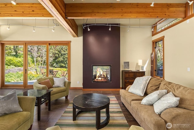 living area with rail lighting, tile patterned floors, and a fireplace