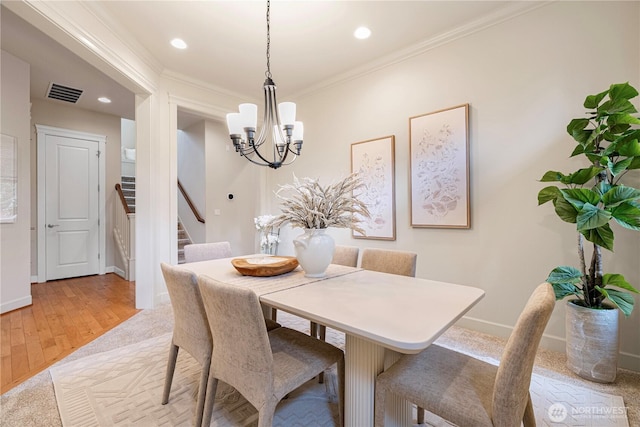 17288 NE 120th Way, Redmond, WA 98052 - dining room with visible vents, a chandelier, light wood-style floors, ornamental molding, and stairs