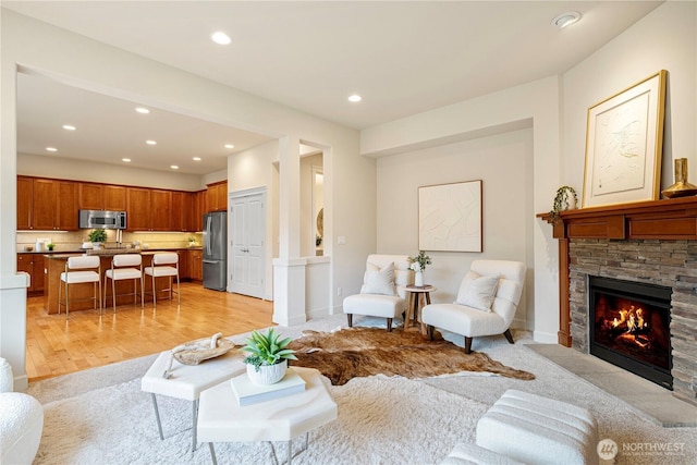 17288 NE 120th Way, Redmond, WA 98052 - living room featuring light wood finished floors, recessed lighting, and a stone fireplace