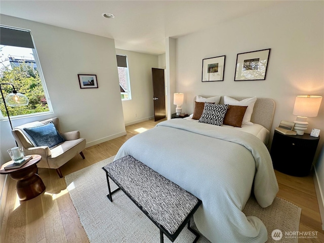 bedroom with baseboards and light wood-type flooring