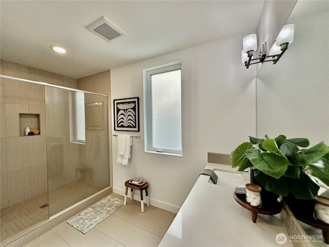 bathroom with visible vents, a stall shower, tile patterned floors, baseboards, and an inviting chandelier