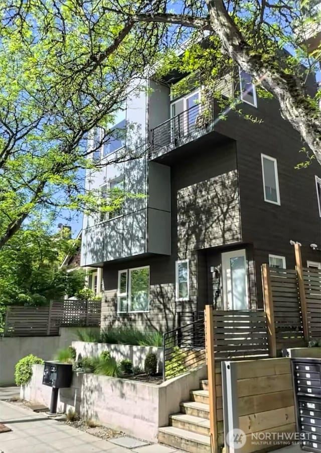back of property with a balcony