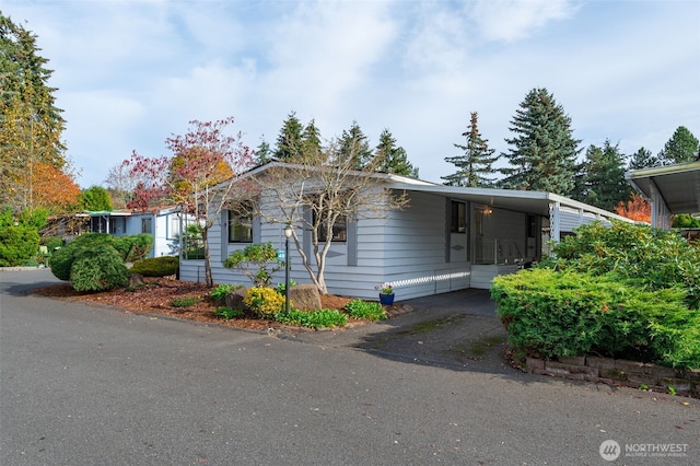 view of front of property with a carport and aphalt driveway