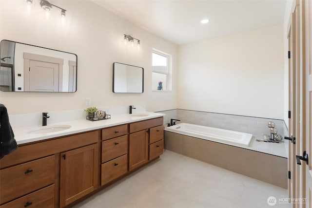 bathroom featuring a garden tub, a sink, and double vanity