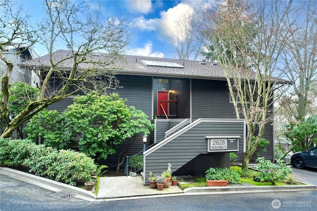 view of front of house with roof with shingles