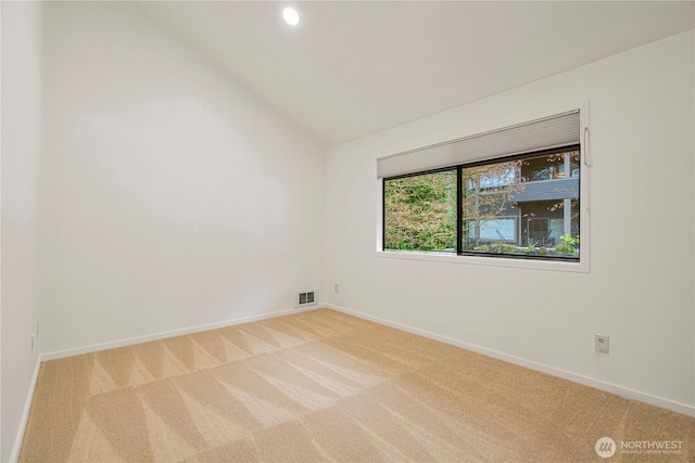 carpeted spare room featuring recessed lighting, vaulted ceiling, visible vents, and baseboards