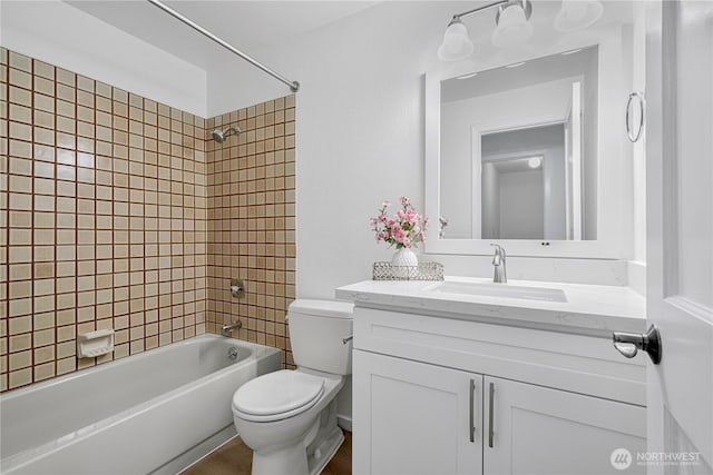 bathroom with shower / bath combination, toilet, and vanity