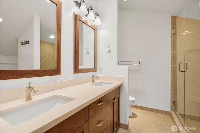 full bathroom featuring a shower stall, toilet, and a sink