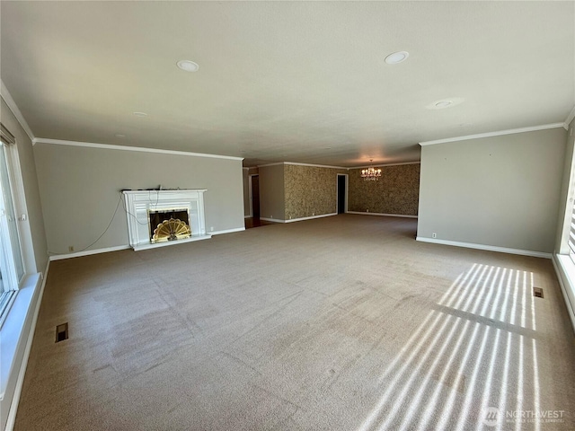 818 E Spring St, Dayton, WA 99328 - unfurnished living room with a chandelier, ornamental molding, a fireplace with raised hearth, baseboards, and carpet flooring