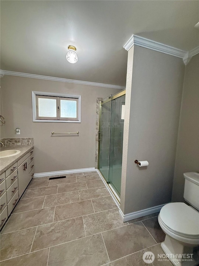 818 E Spring St, Dayton, WA 99328 - full bathroom featuring ornamental molding, vanity, a stall shower, baseboards, and toilet