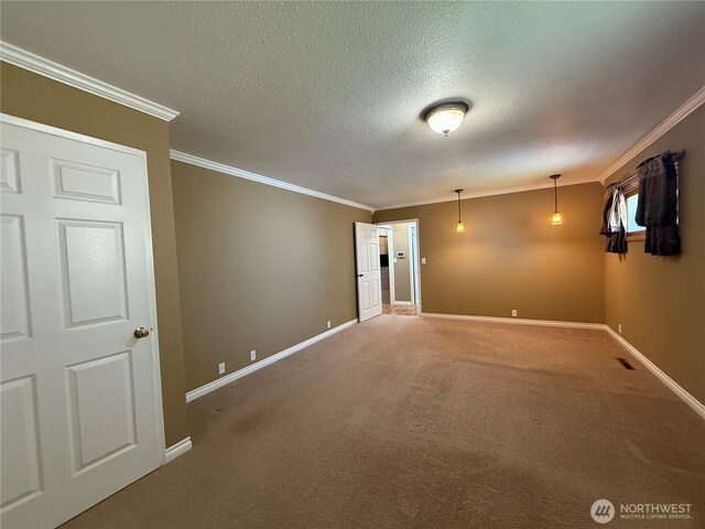 818 E Spring St, Dayton, WA 99328 - carpeted empty room featuring crown molding, baseboards, and a textured ceiling