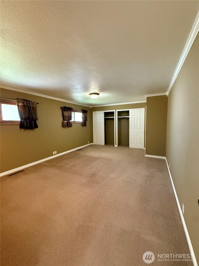 818 E Spring St, Dayton, WA 99328 - unfurnished bedroom with crown molding, a textured ceiling, light carpet, baseboards, and a closet