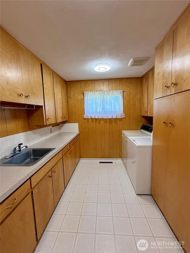 818 E Spring St, Dayton, WA 99328 - washroom with washer and dryer, cabinet space, and wooden walls