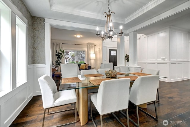 501 125th Ave NE, Lake Stevens, WA 98258 - dining area with crown molding, a chandelier, dark wood-style floors, and a decorative wall