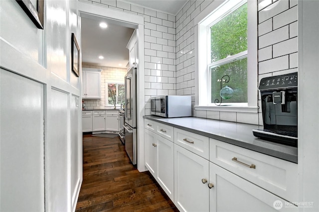 501 125th Ave NE, Lake Stevens, WA 98258 - kitchen featuring a healthy amount of sunlight, tasteful backsplash, stainless steel appliances, white cabinetry, and dark wood-type flooring