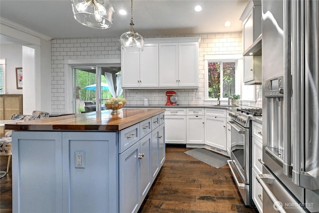501 125th Ave NE, Lake Stevens, WA 98258 - kitchen with dark wood-style flooring, a sink, butcher block countertops, stainless steel appliances, and white cabinetry