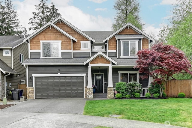 501 125th Ave NE, Lake Stevens, WA 98258 - craftsman-style house featuring fence, stone siding, a garage, a front yard, and concrete driveway