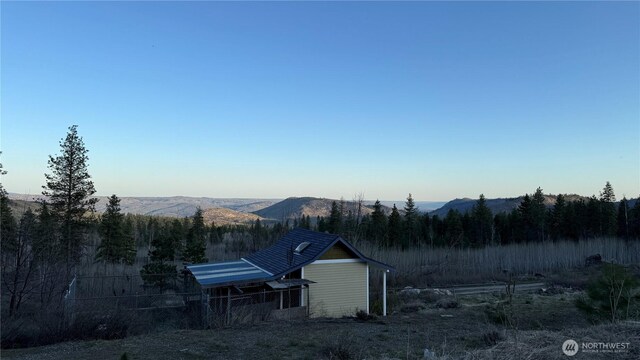 exterior space with a view of trees and a mountain view