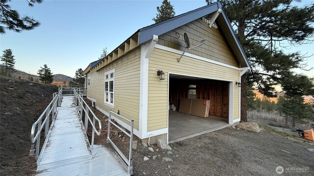 view of property exterior featuring an outdoor structure and a mountain view