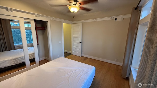 bedroom with baseboards, a ceiling fan, and wood finished floors