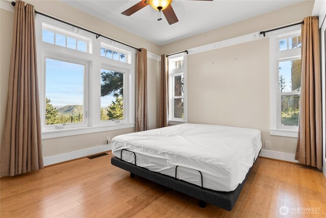 44 Alpine Ln, Okanogan, WA 98840 - bedroom with baseboards, light wood-style floors, and a ceiling fan