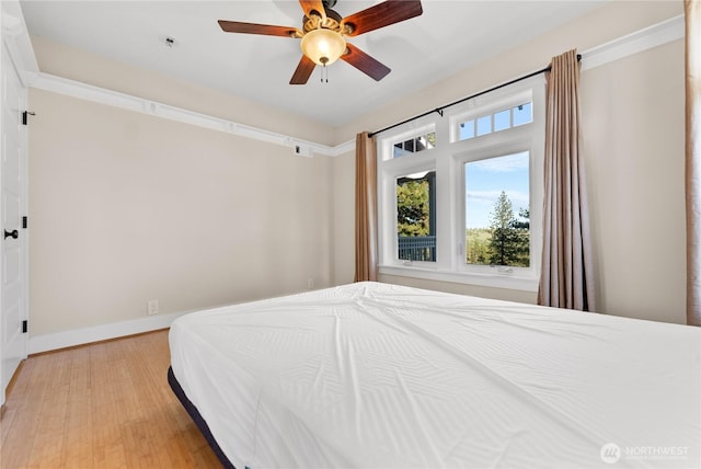 44 Alpine Ln, Okanogan, WA 98840 - bedroom featuring multiple windows, light wood finished floors, a ceiling fan, and baseboards