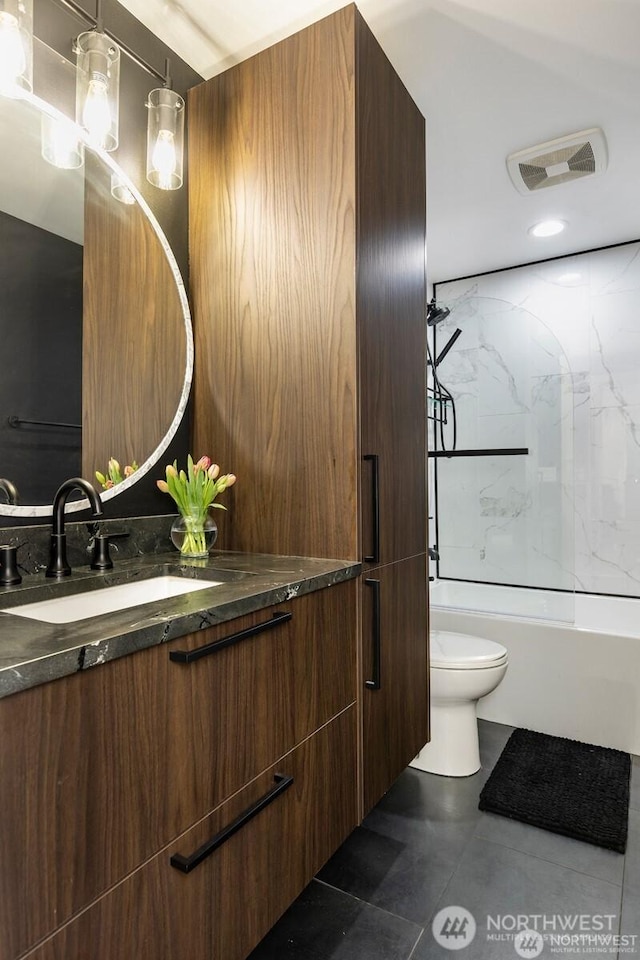 bathroom with toilet, vanity, and tub / shower combination