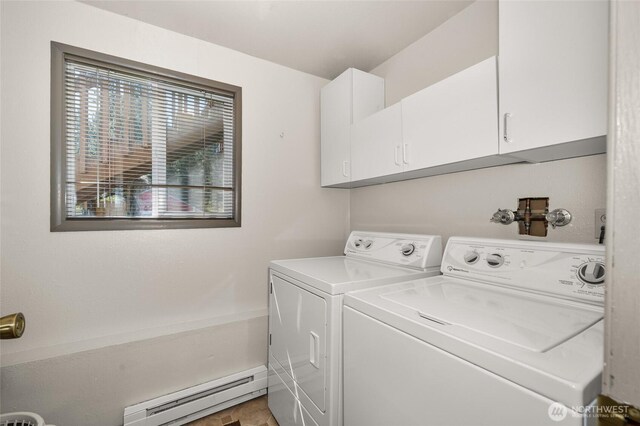 laundry room with baseboard heating, washer and dryer, and cabinet space