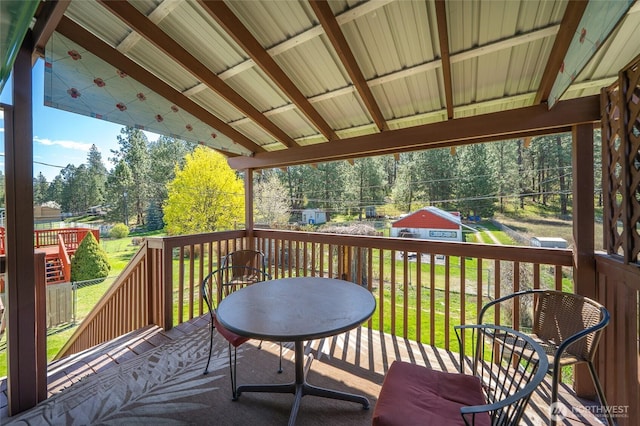 wooden terrace with a lawn