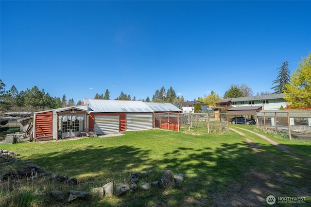 view of yard featuring fence and an outbuilding