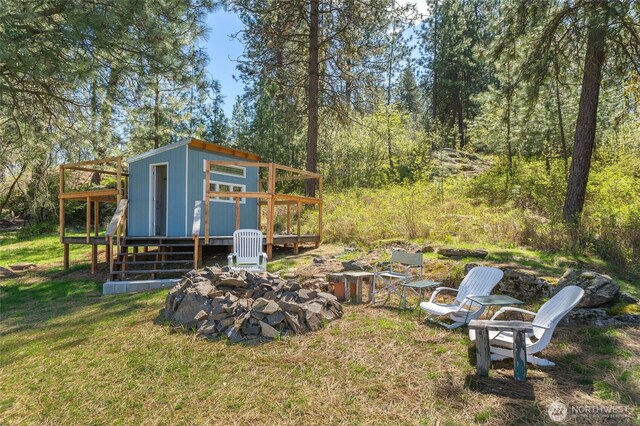view of yard with an outdoor structure and a wooden deck