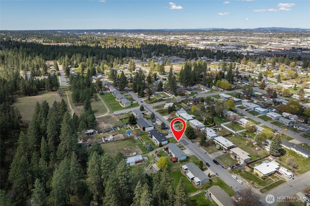 birds eye view of property with a wooded view and a residential view